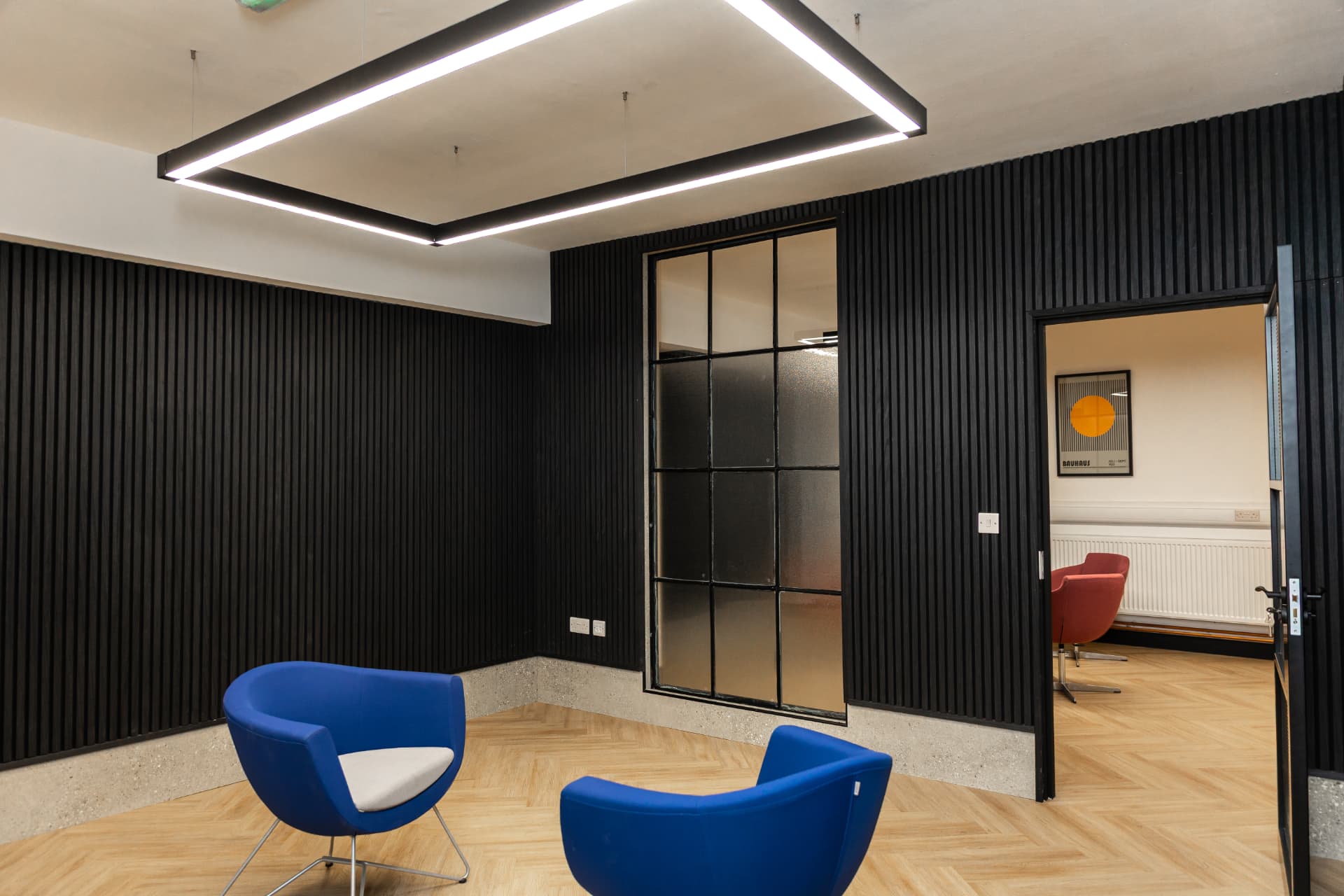 Medium office at Workpoint with modern furniture and an open doorway