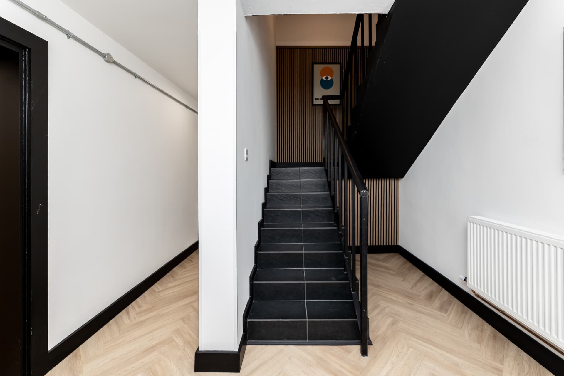 Stairwell at Workpoint with dark stairs and wood slat detailing